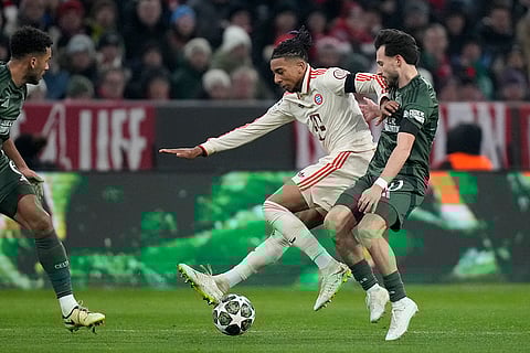 Champions League Soccer playoff second leg: Bayern's Michael Olise challenges for the ball with Celtic's Nicolas Kuehn