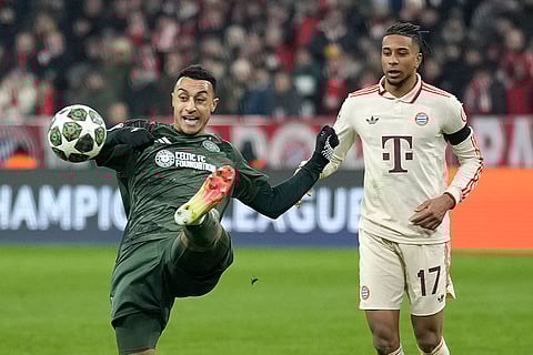 Champions League Soccer playoff second leg: Celtic's Adam Idah, left, kicks the ball ahead of Bayern's Michael Olise