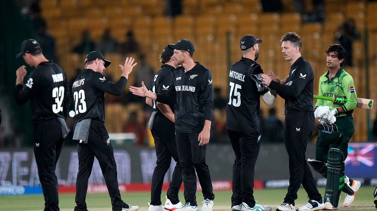 AP Photo/Anjum Naveed : New Zealand's Mitchel Santner, center, and teammates congratulate each others after winning the ICC Champions Trophy cricket match against Pakistan, in Karachi.