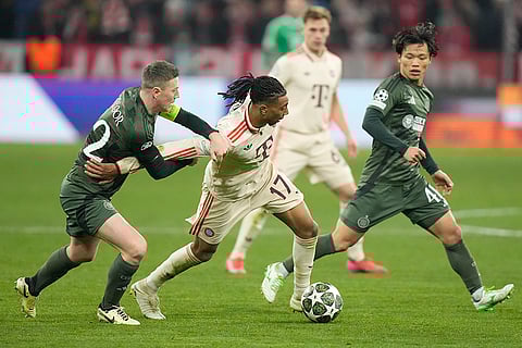 Champions League Soccer playoff second leg: Celtic's Callum McGregor, left, challenges for the ball with Bayern's Michael Olise
