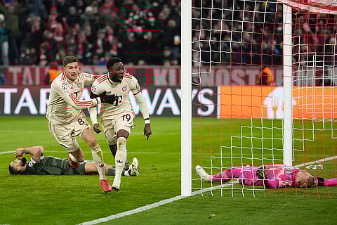 Champions League Soccer playoff second leg: Bayern's Alphonso Davies, centre, celebrates after scoring his side's opening goal