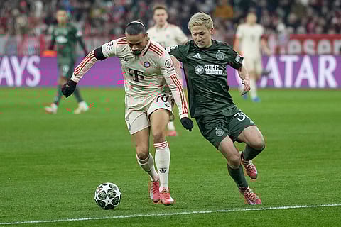 Champions League Soccer playoff second leg: Bayern's Leroy Sane, left, challenges for the ball with Celtic's Daizen Maeda