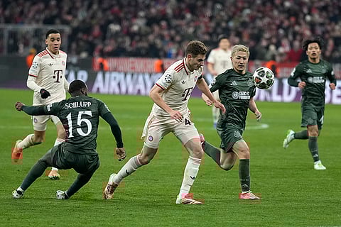 Champions League Soccer playoff second leg: Bayern's Josip Stanisic, centre, challenges for the ball with Celtic's Daizen Maeda
