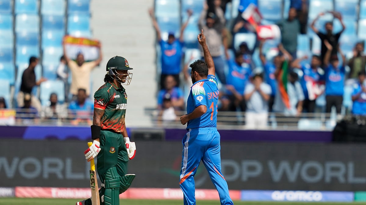 AP Photo/Altaf Qadri : India's Mohammed Shami, right, celebrates the dismissal of Bangladesh's Soumya Sarkar, left, during the ICC Champions Trophy cricket match between India and Bangladesh at Dubai International Cricket Stadium in Dubai.