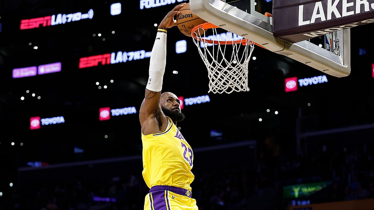 File : LeBron James of the Los Angeles Lakers makes a slam dunk against LaMelo Ball of the Charlotte Hornets in the first half in Los Angeles, California.