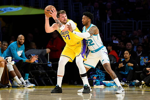 NBA 2024-25: Lakers guard Luka Doncic (77) looks to drive the ball against Hornets guard Elfrid Payton