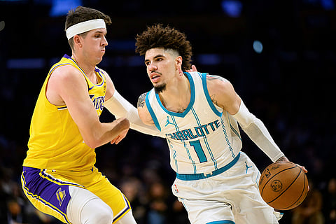 NBA 2024-25: Hornets guard LaMelo Ball (1) drives the ball against Lakers guard Austin Reaves