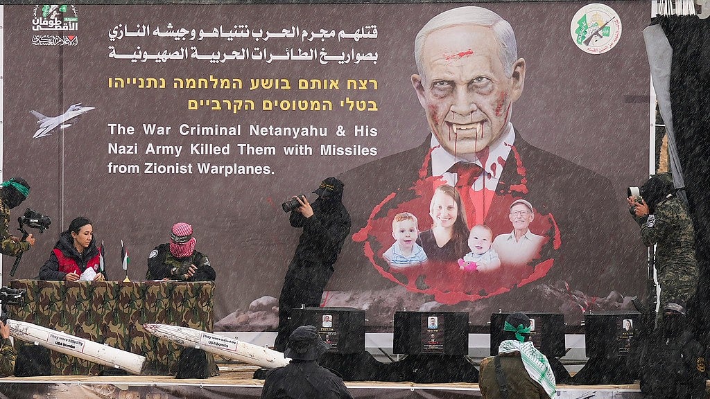 AP : Hamas fighters hand over the coffins containing the bodies of four Israeli hostages, including a mother and her two children, who had long been feared dead, to the Red Cross in Khan Younis, southern Gaza Strip, Thursday, Feb. 20, 2025. 