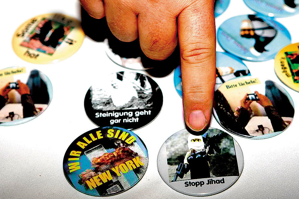 | Photo: Getty Images : Suit Your Agenda: A vendor sells anti-fundamentalist Islam buttons in Berlin on September 3, 2011