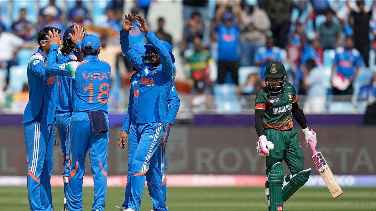 AP Photo/Altaf Qadri : Indian players celebrate the dismissal of Bangladesh's Mushfiqur Rahim, right, during the ICC Champions Trophy cricket match between India and Bangladesh at Dubai International Cricket Stadium in Dubai.