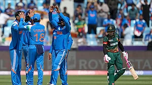 AP Photo/Altaf Qadri : Indian players celebrate the dismissal of Bangladesh's Mushfiqur Rahim, right, during the ICC Champions Trophy cricket match between India and Bangladesh at Dubai International Cricket Stadium in Dubai.