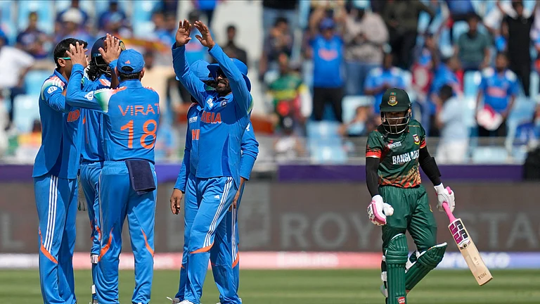 Indian players celebrate the dismissal of Bangladesh's Mushfiqur Rahim, right, during the ICC Champions Trophy cricket match between India and Bangladesh at Dubai International Cricket Stadium in Dubai. - AP Photo/Altaf Qadri