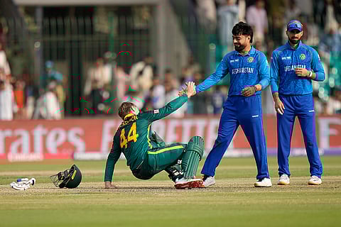 Champions Trophy 2025 Match 3, AFG vs SA: South Africa's Ryan Rickelton is helped by Rashid Khan after his dismissal