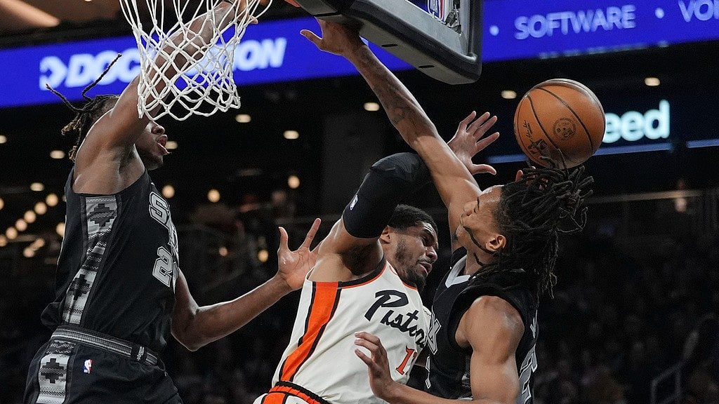 Photo: AP : Detroit Pistons forward Tobias Harris, centre, is fouled as he drives to the basket against San Antonio Spurs guard Devin Vassell (24) and centre Charles Bassey (28) during an NBA game in Austin, Texas.