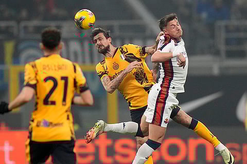 Serie A, Inter Milan and Genoa: Genoa's Andrea Pinamonti challenges for the ball with Inter Milan's Francesco Acerbi