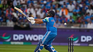 AP Photo/Altaf Qadri : India's captain Rohit Sharma plays a shot during the ICC Champions Trophy cricket match between India and Pakistan at Dubai International Cricket Stadium.