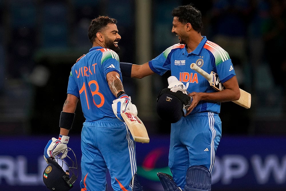 | Photo: AP/Altaf Qadri : ICC Champions Trophy, IND vs PAK: India's Virat Kohli, left, and Axar Patel celebrate after winning the match