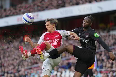 EPL Arsenal vs West Ham: Arsenal's Leandro Trossard challenges for the ball with West Ham's Aaron Wan-Bissaka