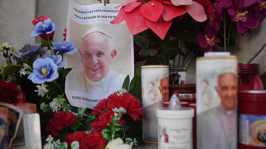 AP : Candles and a photo of Pope Francis are seen in front of the Agostino Gemelli Polyclinic, in Rome, Saturday, Feb. 22, 2025, where the Pontiff is hospitalized since Friday, Feb. 14.