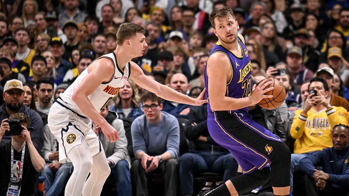 Christian Braun (0) of the Denver Nuggets locks up Luka Doncic (77) of the Los Angeles Lakers during the second quater at Ball Arena in Denver, Colorado on Saturday, February 22, 2025.
