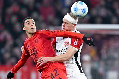 Bundesliga 2024-25, Bayern vs Eintracht: Jamal Musiala of Munich and Rasmus Kristensen of Frankfurt