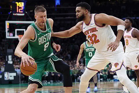 NBA 2024-25, Knicks vs Celtics: Celtics' Kristaps Porzingis (8) looks to move against Knicks' Karl-Anthony Towns