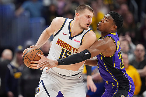 NBA 2024-25, Lakers vs Nuggets: Nuggets center Nikola Jokic, left, looks to pass the ball
