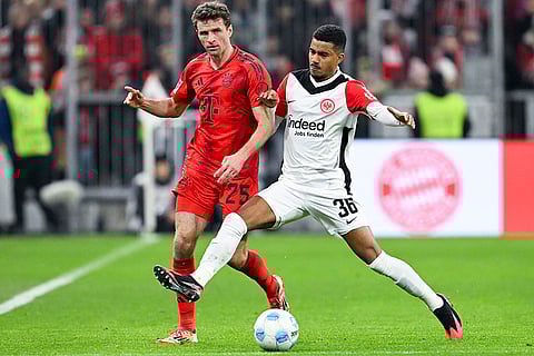 Bundesliga 2024-25, Bayern vs Eintracht: Thomas Muller of Munich and Ansgar Knauff of Frankfurt in action