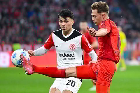 Bundesliga 2024-25, Bayern vs Eintracht: Joshua Kimmich of Munich and Can Uzun of Frankfurt in action