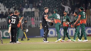 AP : New Zealand's Glenn Phillips, left, and Michael Bracewell, second right, shake hands with Bangladesh's players at the end of their Champions Trophy match in Rawalpindi.
