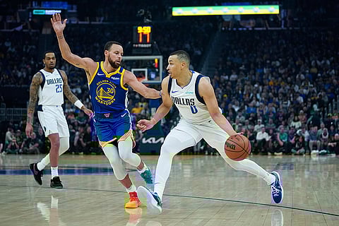 NBA 2024-25, Mavericks vs Warriors: Warriors guard Stephen Curry, rear, pokes the ball away from Dallas Mavericks guard Max Christie
