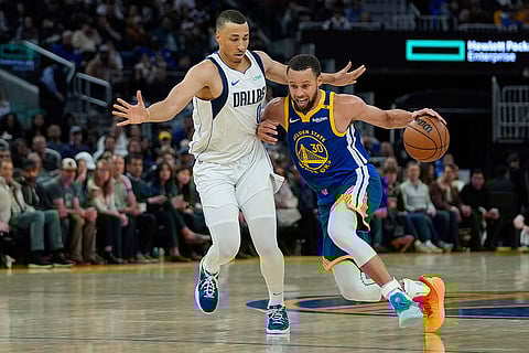 NBA 2024-25, Mavericks vs Warriors: Warriors guard Stephen Curry, right, moves the ball
