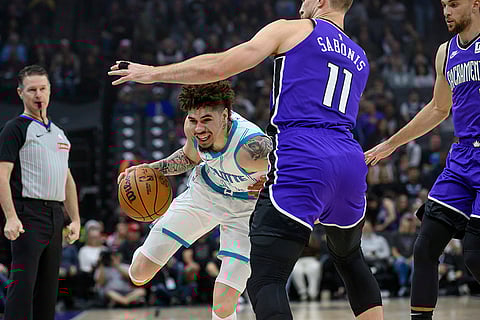 NBA 2024-25: Hornets guard LaMelo Ball drives past Kings forward Domantas Sabonis