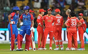 (PTI Photo/Shailendra Bhojak) : Bengaluru: Delhi Capitals' batters Jess Jonassen and Shafali Verma interact with each other as Gujarat Giants' players wait for third umpire's decision during a Women's Premier League (WPL) 2025 cricket match between Delhi Capitals and Gujarat Giants, at the M Chinnaswamy Stadium, in Bengaluru, Tuesday, Feb. 25, 2025.
