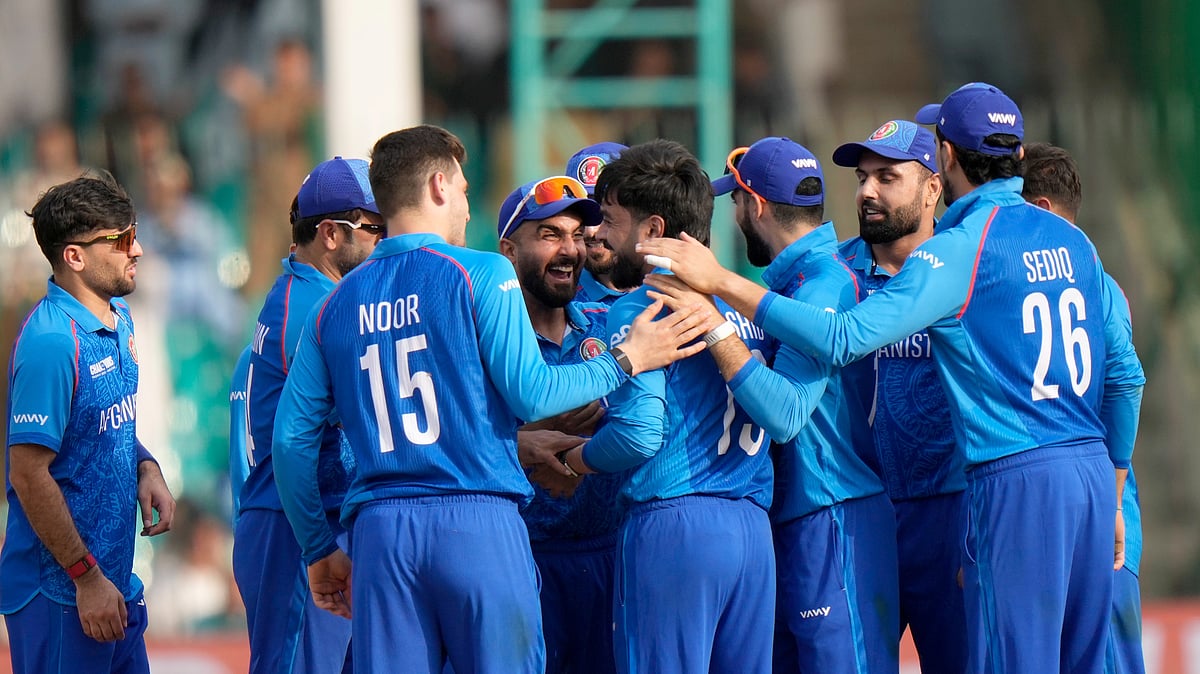 AP Photo/Anjum Naveed : Afghanistan's Rashid Khan, centre, celebrates with teammates after the dismissal of South Africa's Ryan Rickelton during the ICC Champions Trophy cricket match between Afghanistan and South Africa, in Karachi.