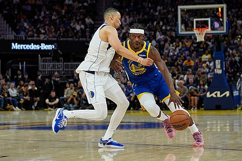 NBA 2024-25, Mavericks vs Warriors: Warriors forward Jimmy Butler III, right, moves the ball
