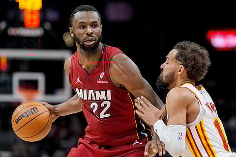 NBA 2024-25: Heat forward Andrew Wiggins (22) drives against Hawks guard Trae Young