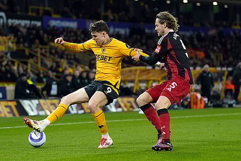 EPL 2024-25, Wolves and Fulham: Wolves Jorgen Strand Larsen holds off Fulham's Joachim Andersen