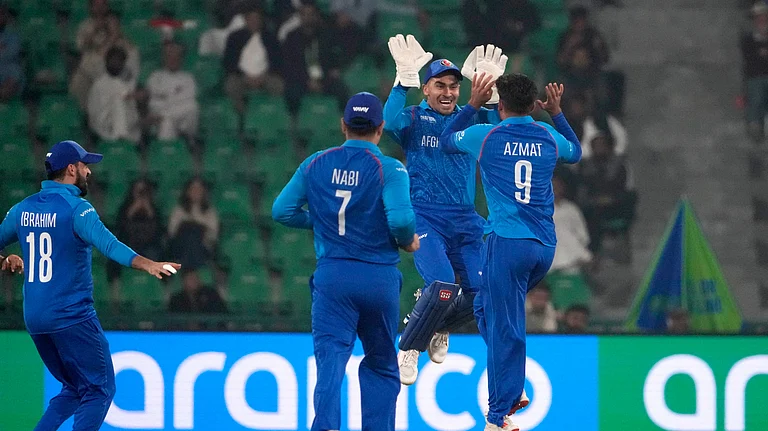Afghanistan's Azmatullah Omarzai, right, celebrates with teammates after the dismissal of England's Philip Salt during the ICC Champions Trophy cricket match between Afghanistan and England, in Lahore. - AP Photo/K.M. Chaudary