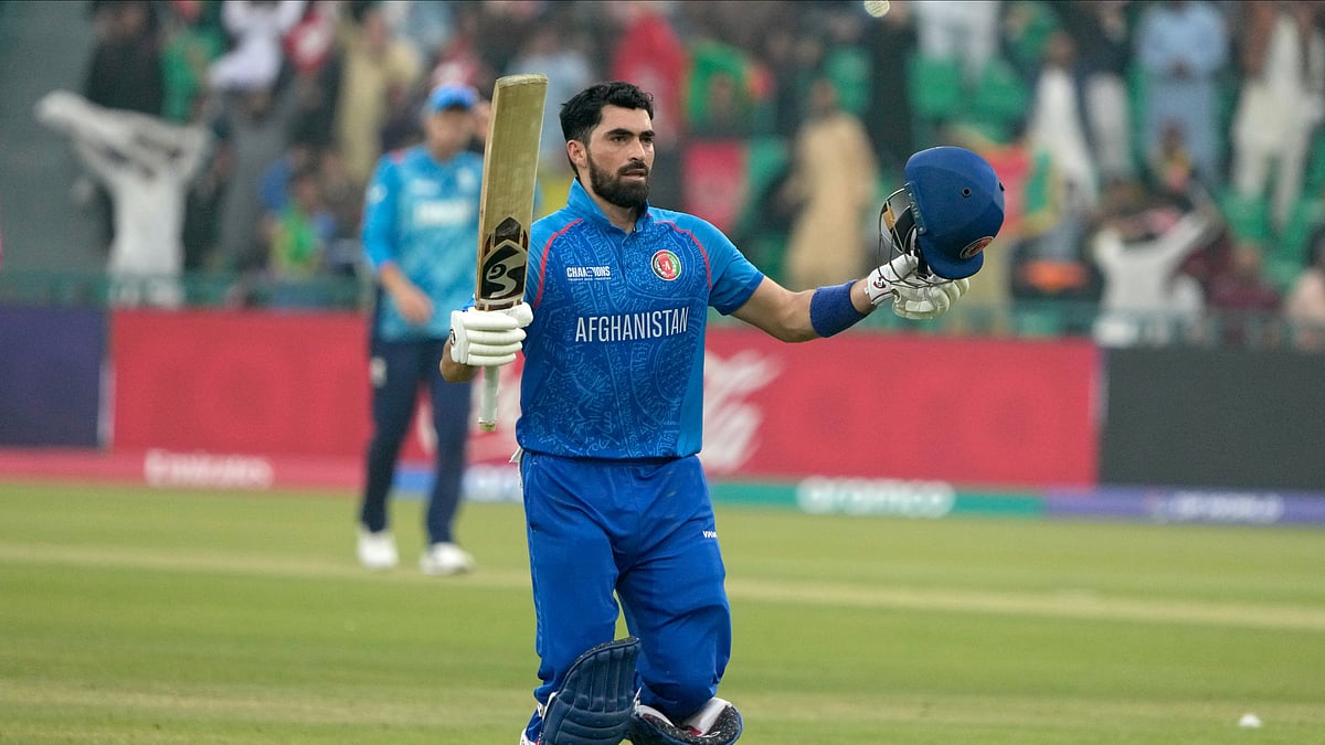 AP Photo/K.M. Chaudary : Afghanistan's Ibrahim Zadran celebrates after scoring a century during the ICC Champions Trophy cricket match between Afghanistan and England, in Lahore.