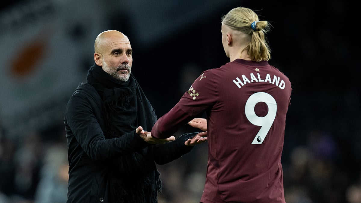 Pep Guardiola and Erling Haaland pictured after Manchester City's win. - null