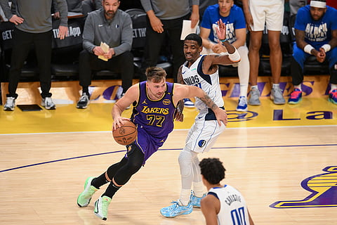 NBA 2024-25: Lakers guard Luka Doncic (77) moves the ball while defended by Mavericks guard Kyrie Irving