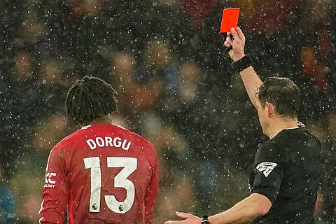 EPL 2024-25: Referee Darren England shows a red card to Manchester United's Patrick Dorgu