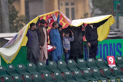 ICC Champions Trophy, PAK vs BAN: Fans stand under a sheet during rain