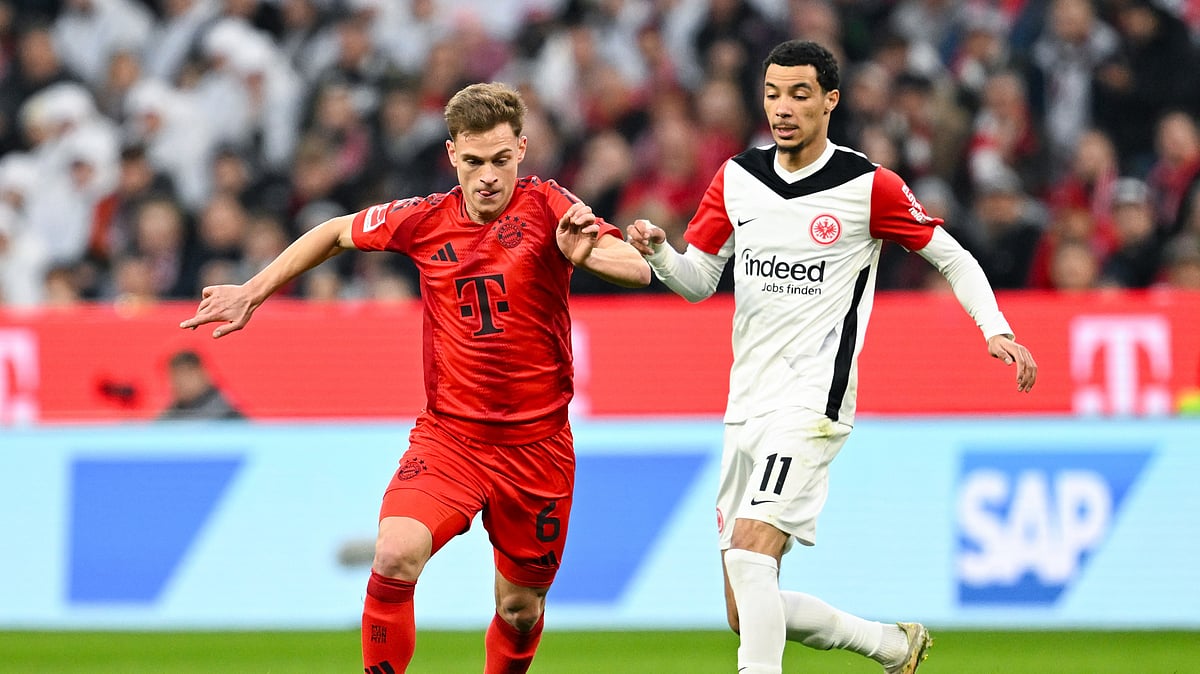 Sven Hoppe/dpa via AP : Munich's Joshua Kimmich, left, and Frankfurt's Hugo Ekitike in action during the Bundesliga soccer match between Bayern Munich and Eintracht Frankfurt at the Allianz Arena, Munich, Germany.