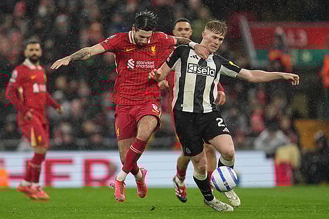 EPL 2024-25: Newcastle's Lewis Hall is challenged by Liverpool's Dominik Szoboszlai