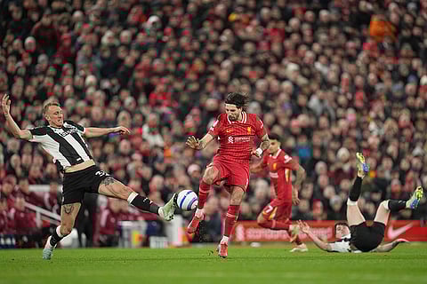 EPL 2024-25: Newcastle's Dan Burn challenges Liverpool's Dominik Szoboszlai