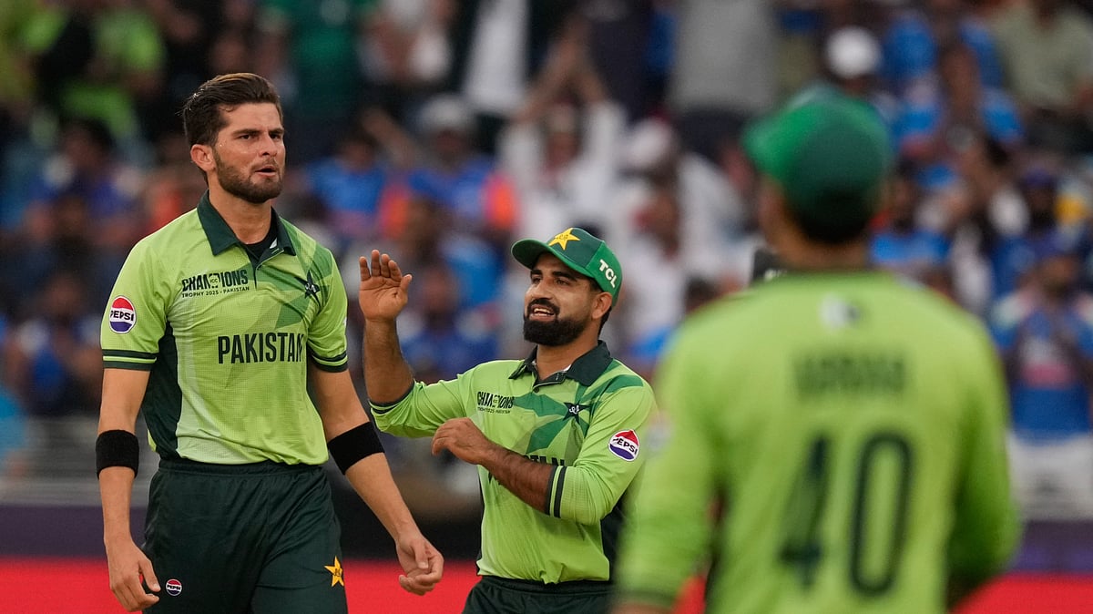 AP Photo/Altaf Qadri : Pakistan's Shaheen Afridi, left, celebrates with teammate the wicket of India's captain Rohit Sharma during the ICC Champions Trophy cricket match between India and Pakistan at Dubai International Cricket Stadium.