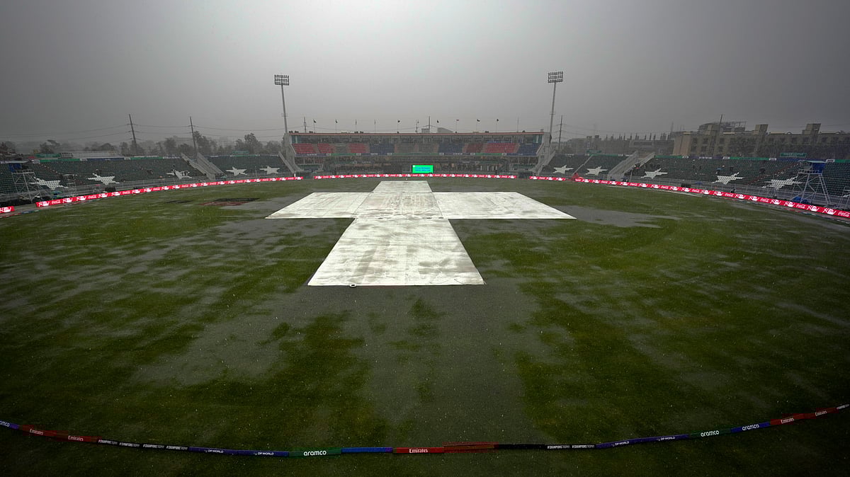 AP Photo/Anjum Naveed : The pitch and ground covers as heavy rain fall before start of the ICC Champions Trophy cricket match between Pakistan and Bangladesh, in Rawalpindi.