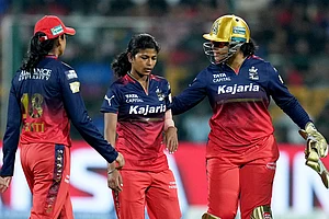 | Photo: AP/Shailendra Bhojak : WPL 2025, RCB vs GG: Bengaluru’s captain Smriti Mandhana, Prema Rawat and wicketkeeper Richa Ghosh